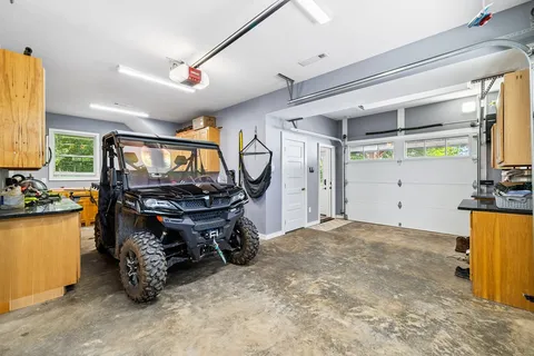 a room with lots of wooden furniture and a window