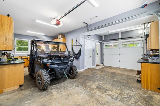 a room with lots of wooden furniture and a window