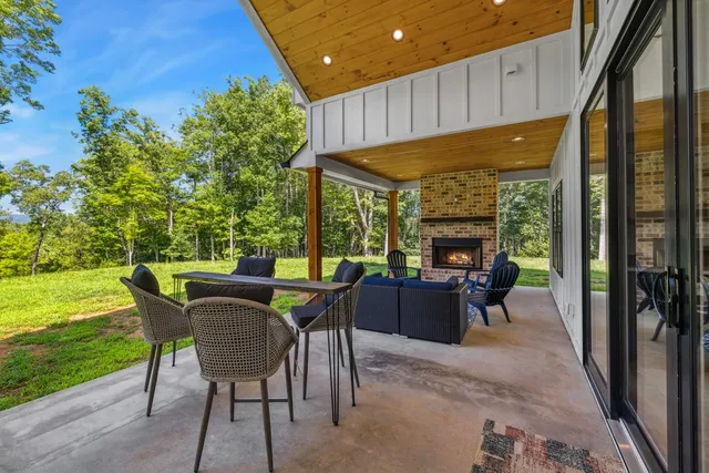 a view of a patio with table and chairs