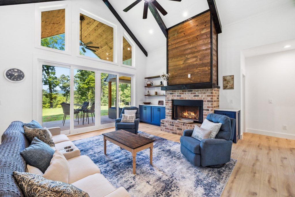 60 Buckeye Branch Road Morganton, GA 30560 - Photo 5 of 51 a living room with furniture a large window and a fireplace