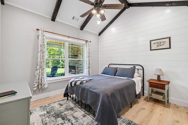 a bed sitting in a bedroom next to a window