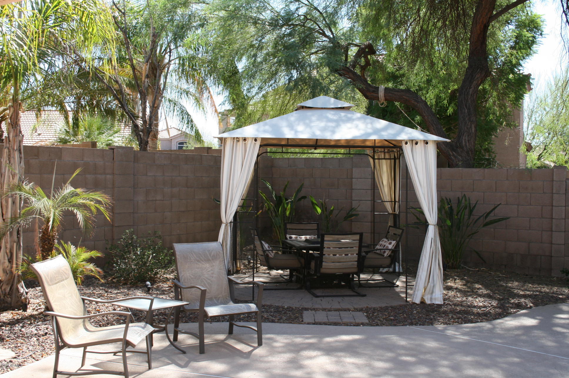 4519 East Rowel Road Phoenix, AZ 85050 - Photo 13 of 28 a view of a patio with table and chairs and potted plants
