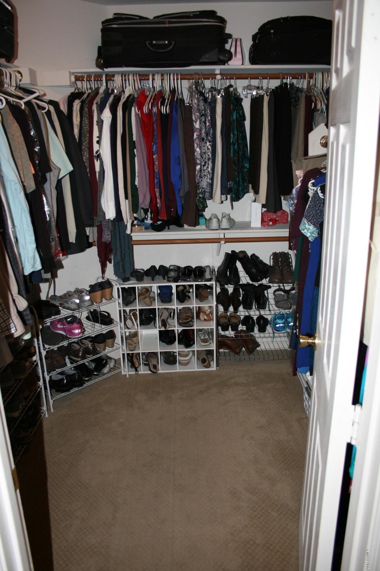 4519 East Rowel Road Phoenix, AZ 85050 - Photo 23 of 28 a view of walk in closet with clothes and shoes