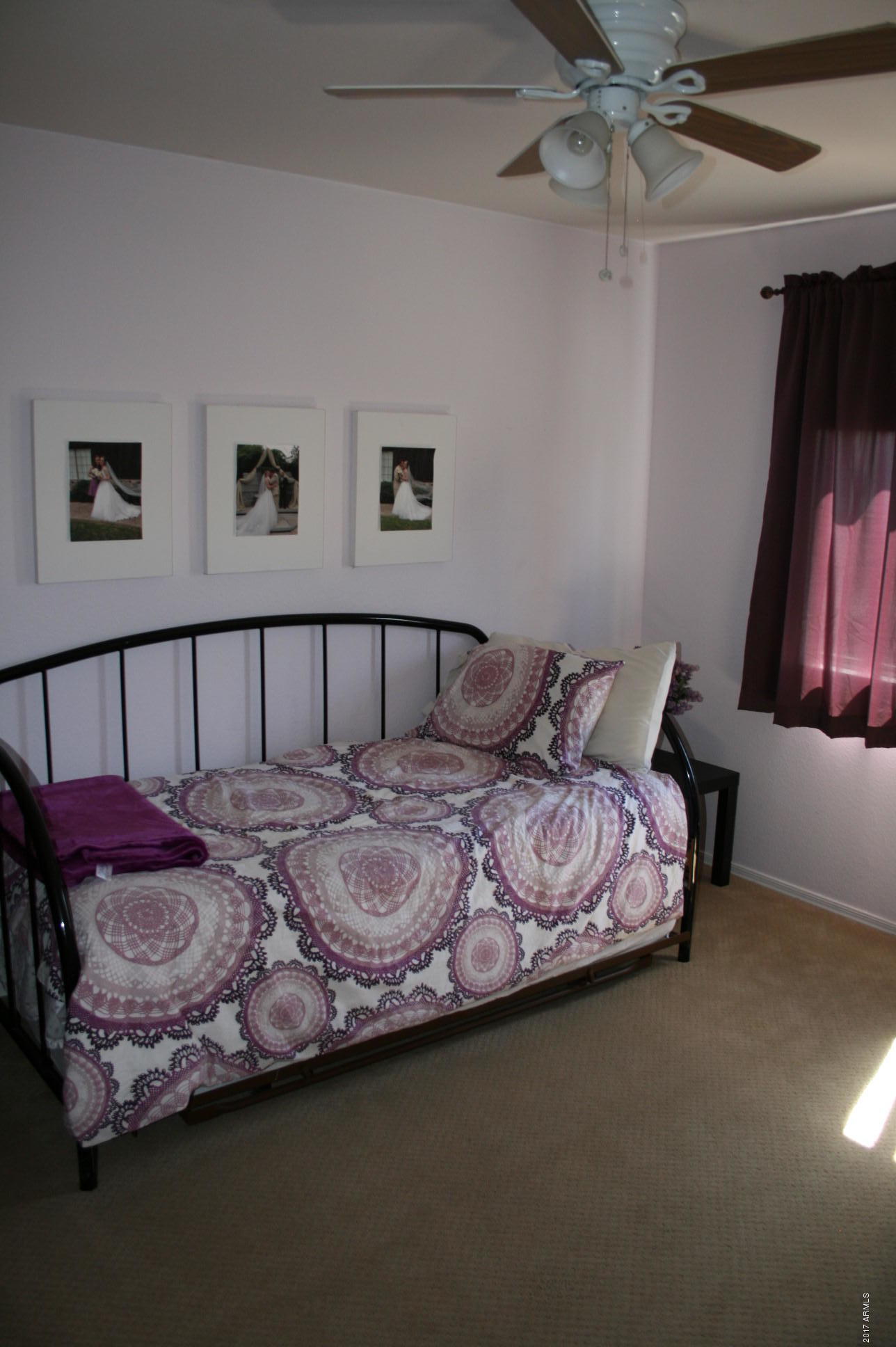 4519 East Rowel Road Phoenix, AZ 85050 - Photo 25 of 28 a bedroom with a bed and a chandelier