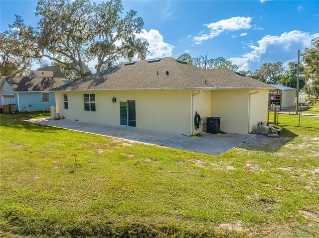 a view of a house with swimming pool and a yard