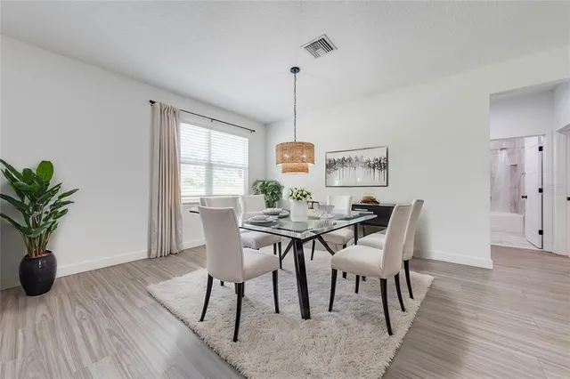 a view of a dining room with furniture window and wooden floor