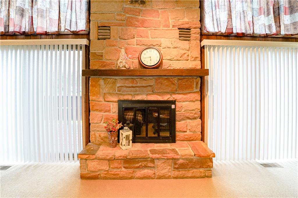 809 Enterprise Road Grove City, PA 16127 - Photo 18 of 43 a living room with a fireplace and a window