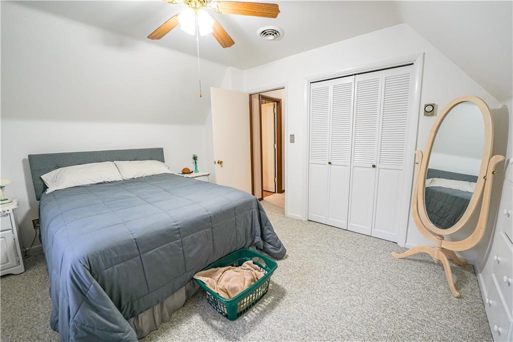 809 Enterprise Road Grove City, PA 16127 - Photo 31 of 43 a bedroom with a bed a mirror and lamp