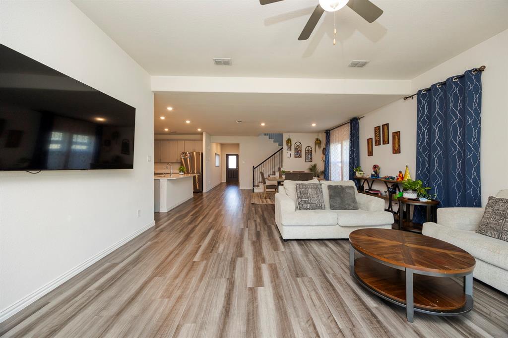495 Fox Ridge Drive Princeton, TX 75407 - Photo 15 of 31 Open-concept living area featuring wood-finish flooring, recessed lighting, a ceiling fan, and a kitchen with an island