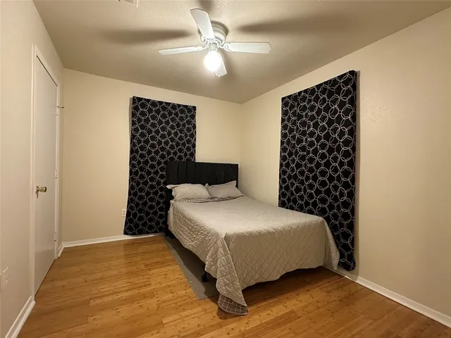 a bedroom with a bed and a wall painting