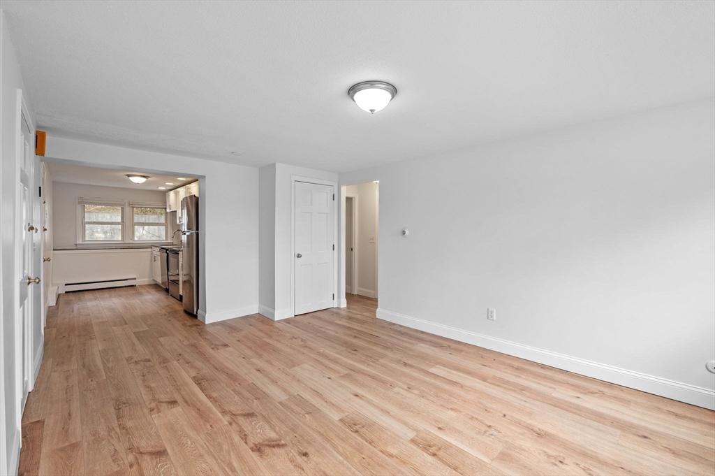 121 Cambridge Road, Unit 2 Woburn, MA 01801 - Photo 4 of 23 a view of empty room with wooden floor