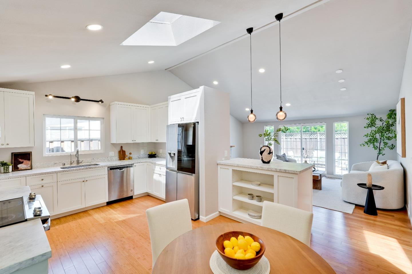 1755 Ravizza Avenue Santa Clara, CA 95051 - Photo 12 of 36 a large white kitchen with lots of counter space and stainless steel appliances