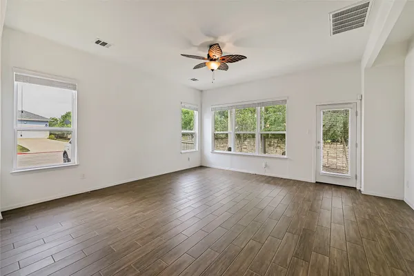 a kitchen with stainless steel appliances a stove top oven a sink dishwasher and a microwave oven on the wooden floor