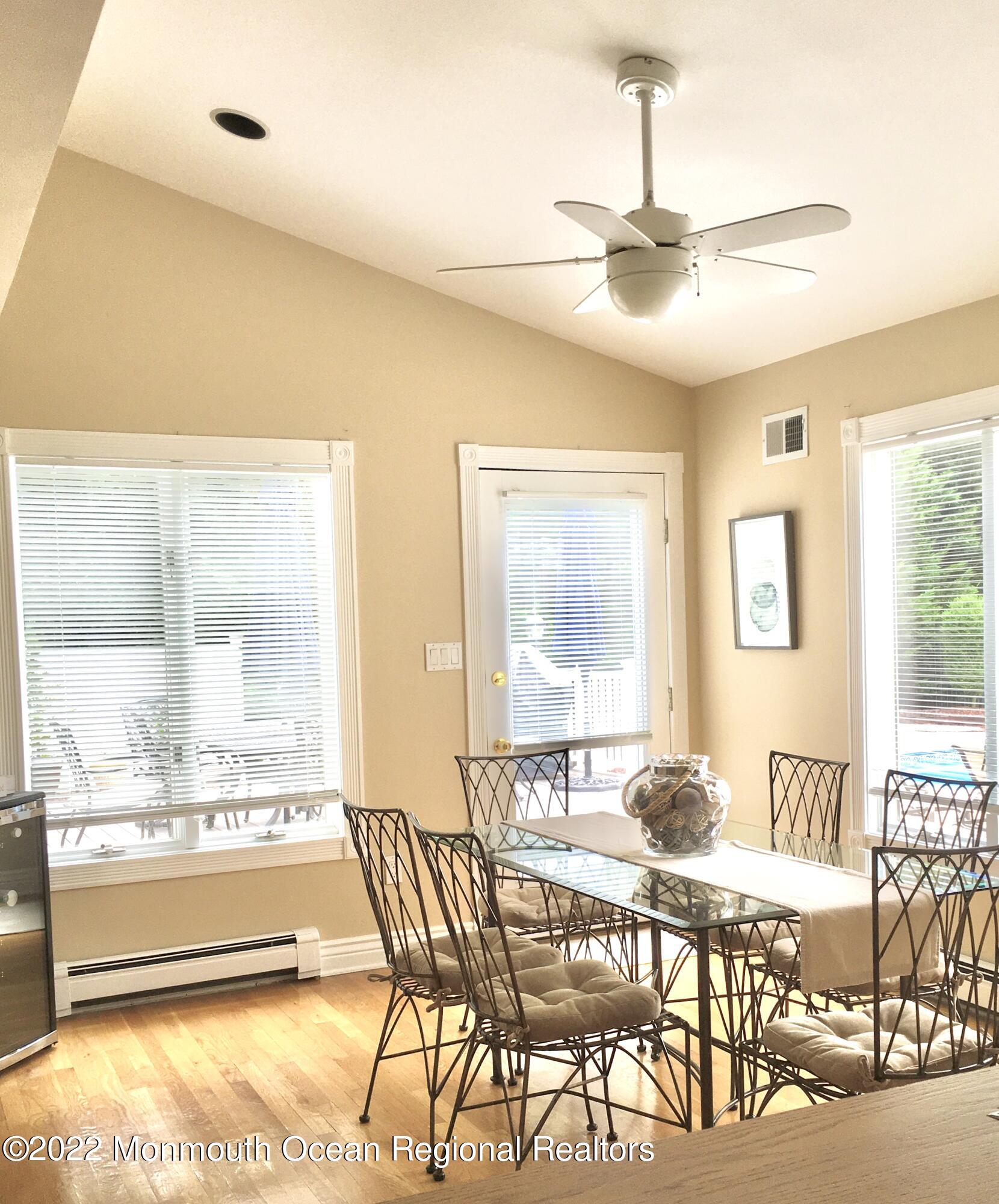 30 Homestead Road Freehold, NJ 07728 - Photo 24 of 42 a dining hall with stainless steel appliances kitchen island granite countertop a table and chairs