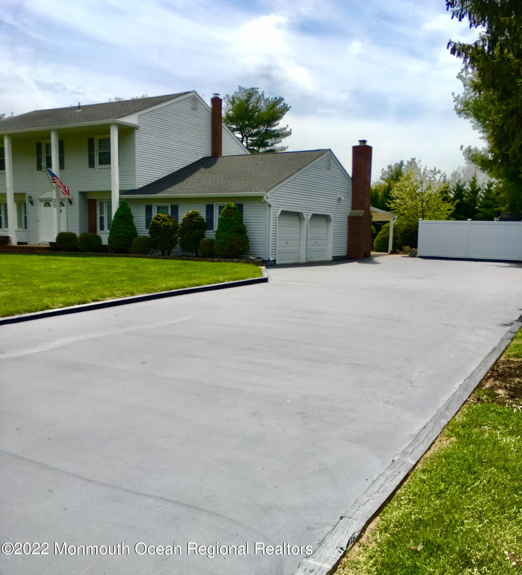 30 Homestead Road Freehold, NJ 07728 - Photo 3 of 42 a front view of a house with a yard and garage