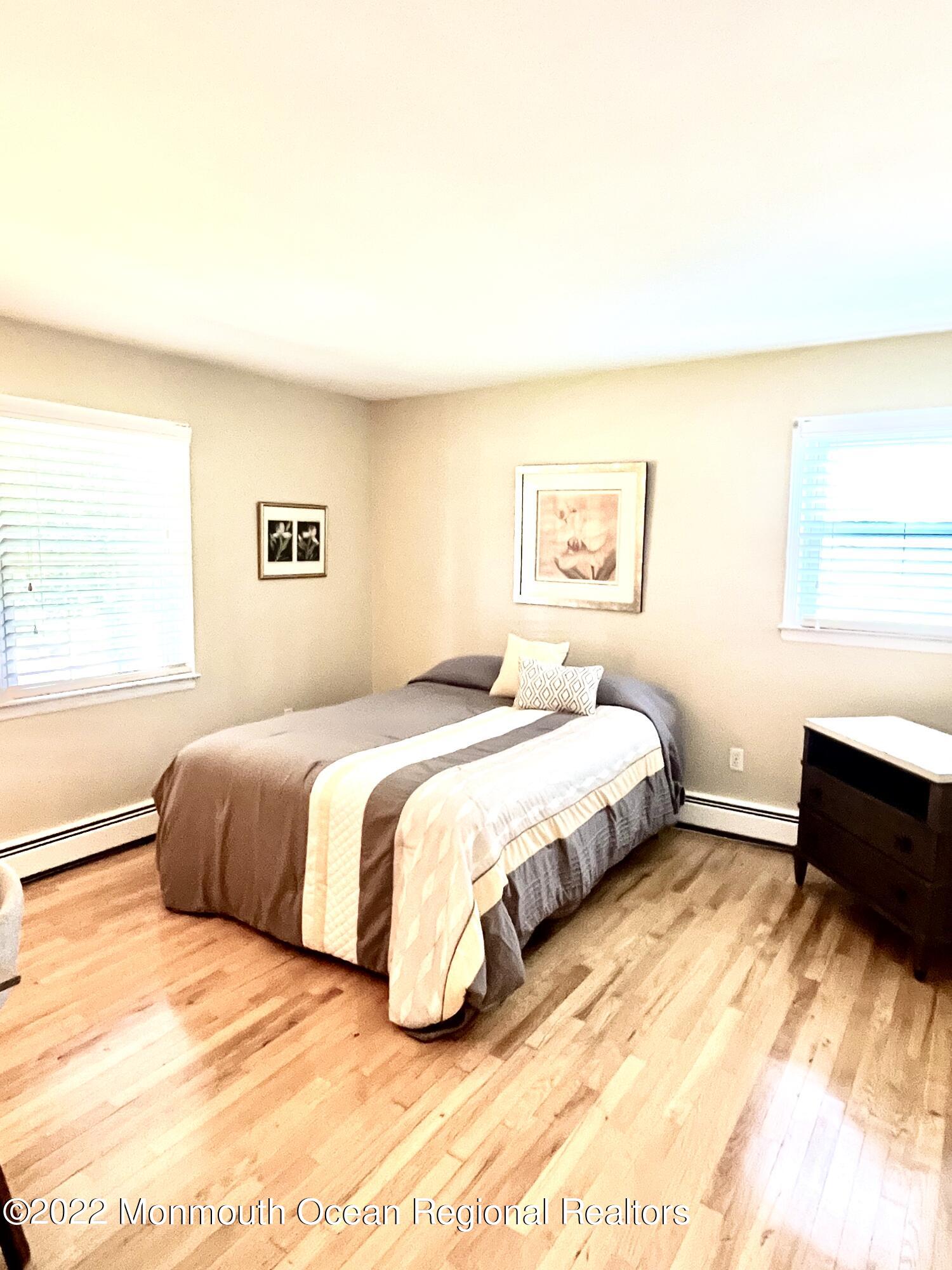 30 Homestead Road Freehold, NJ 07728 - Photo 40 of 42 a spacious bedroom with a bed and a couch