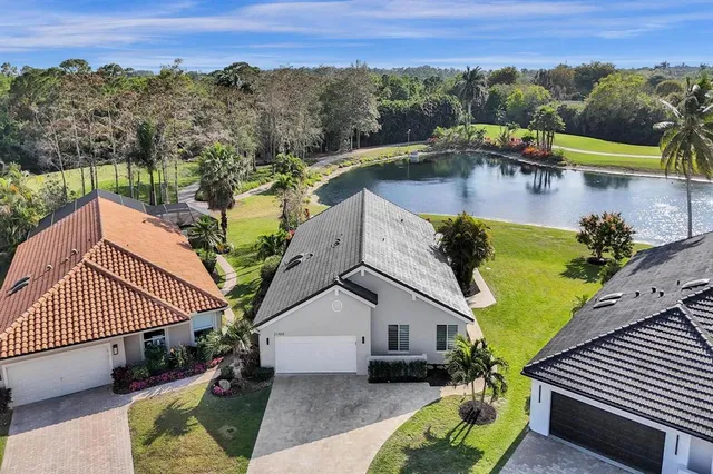 an aerial view of a house with swimming pool and a yard
