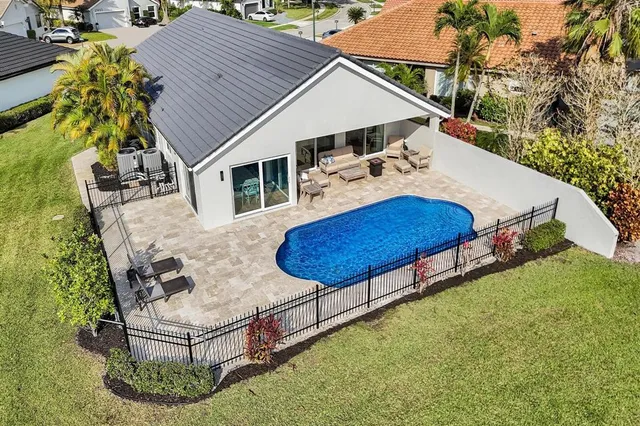 a view of a house with pool and a yard