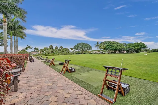 a view of a tennis ground with large trees