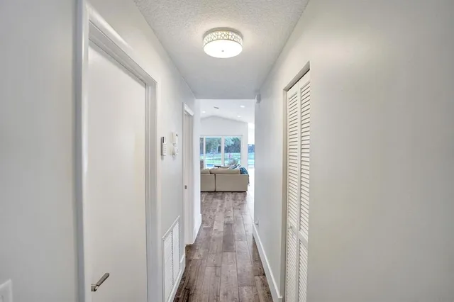 a kitchen with granite countertop a sink and cabinets