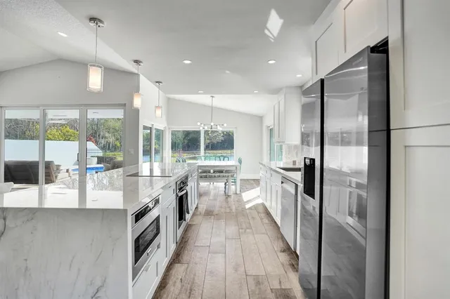 a large white kitchen with a large window