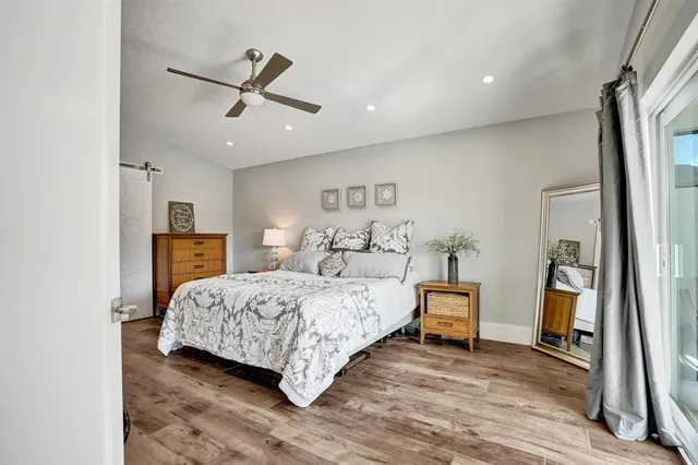 a bedroom with a bed and wooden floor