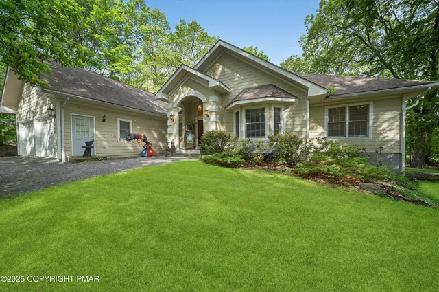 a front view of house with yard and green space
