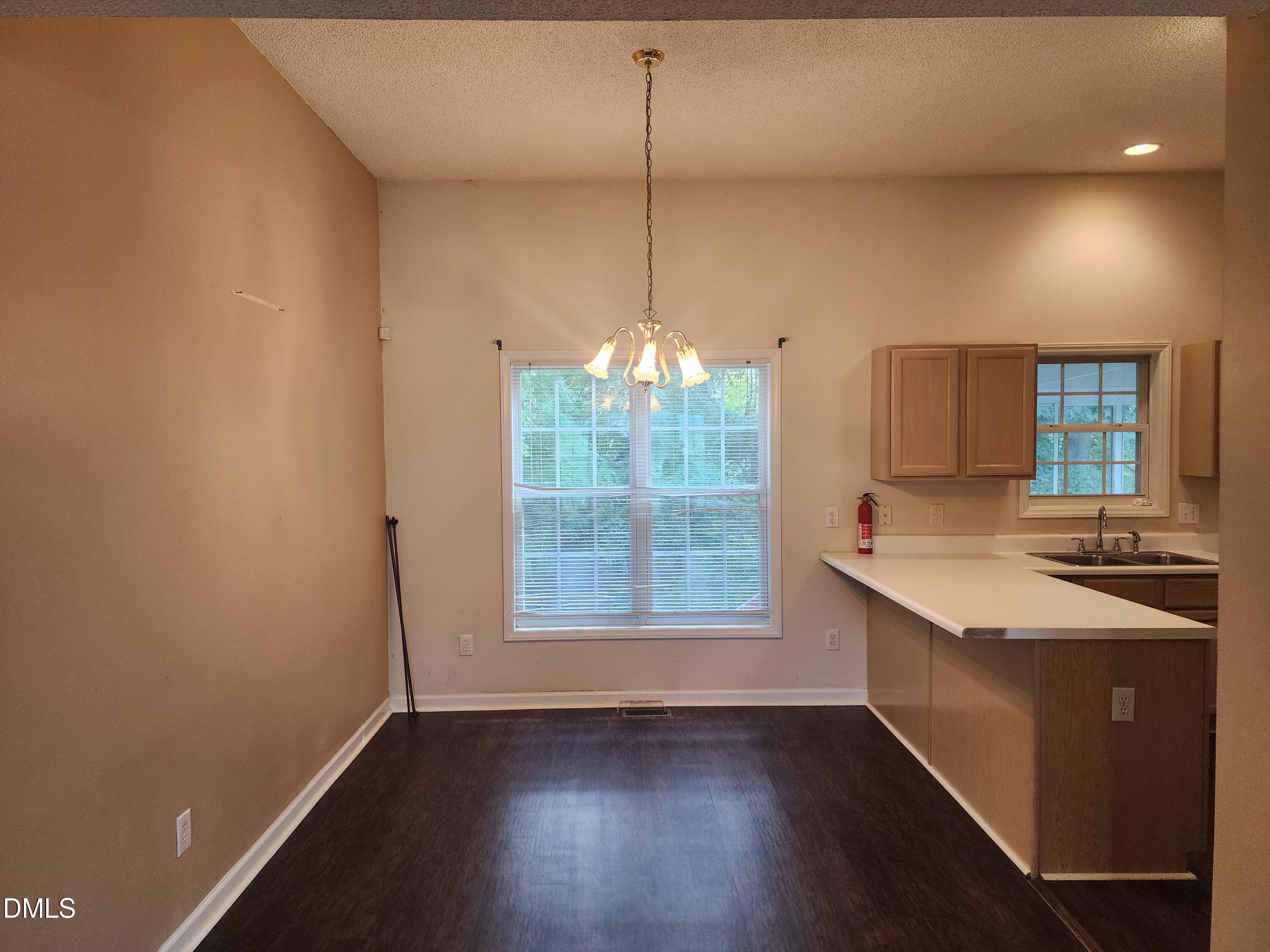 518 Johnson Street Garner, NC 27529 - Photo 5 of 17 a kitchen with kitchen island a sink appliances and cabinets
