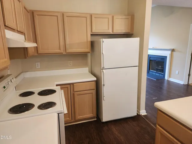 a white refrigerator freezer sitting inside of a kitchen