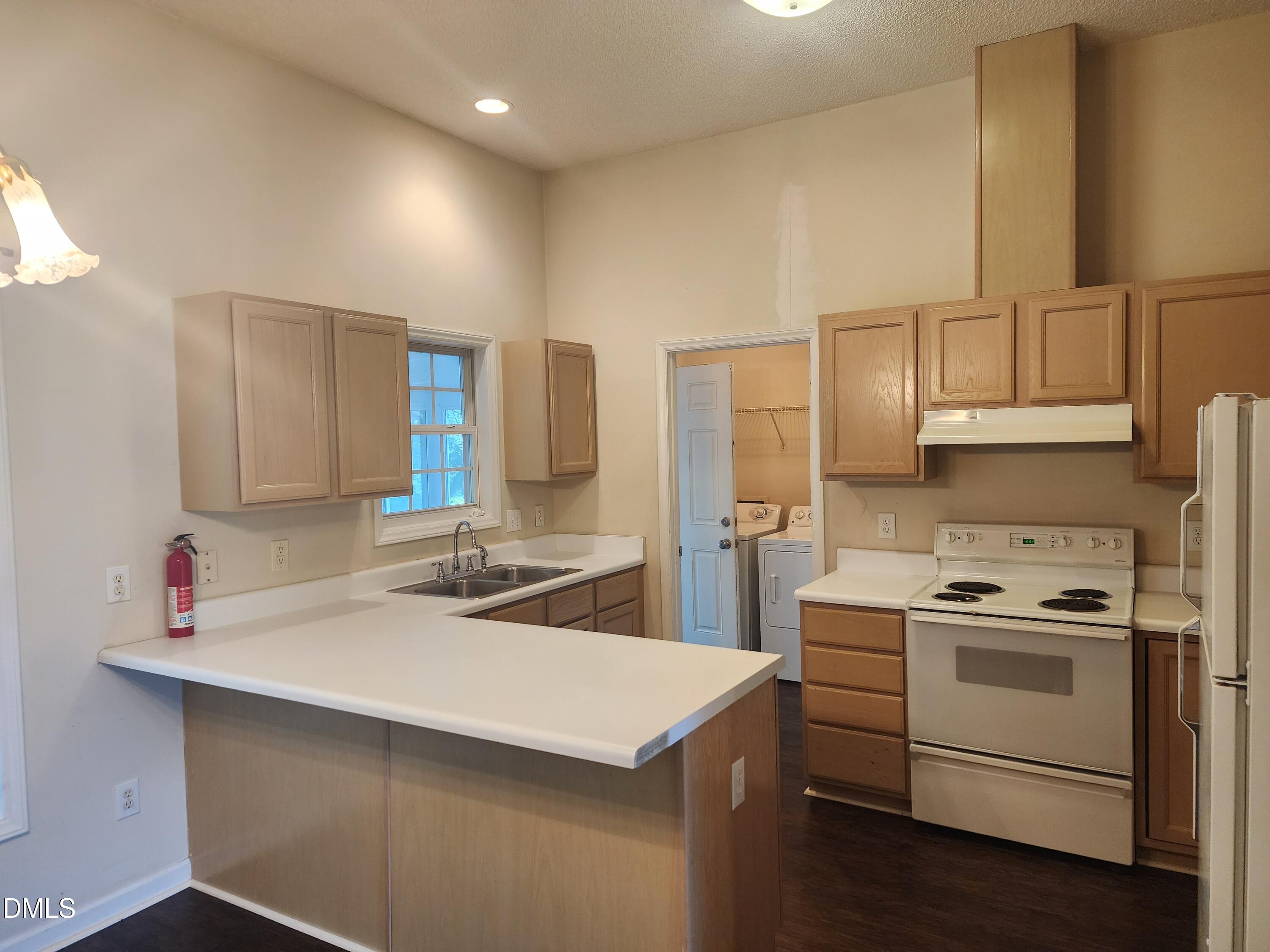 518 Johnson Street Garner, NC 27529 - Photo 7 of 17 a kitchen with a sink a stove and cabinets