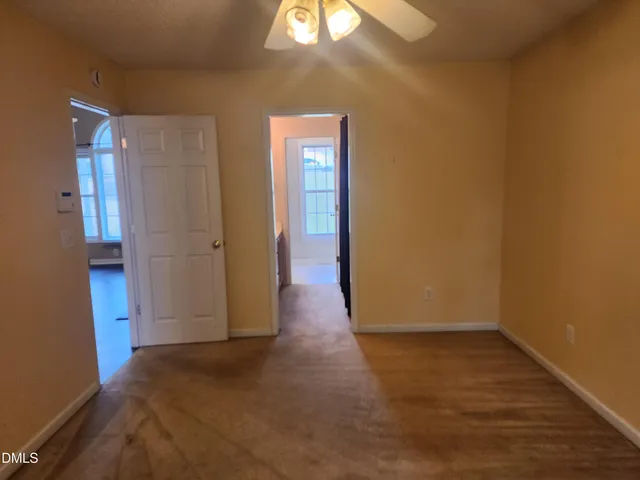 a view of a room with wooden floor and a window