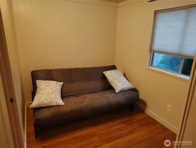 a living room with a couch and a potted plant