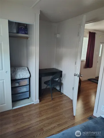 a room with wooden floor and furniture