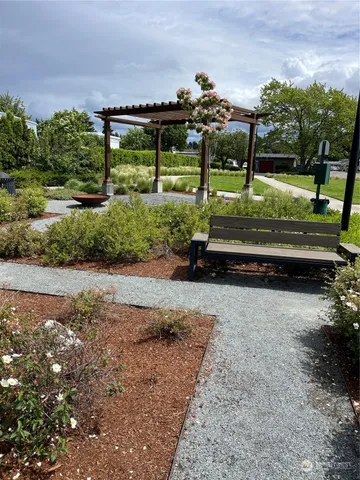 a view of a garden with a building in the background