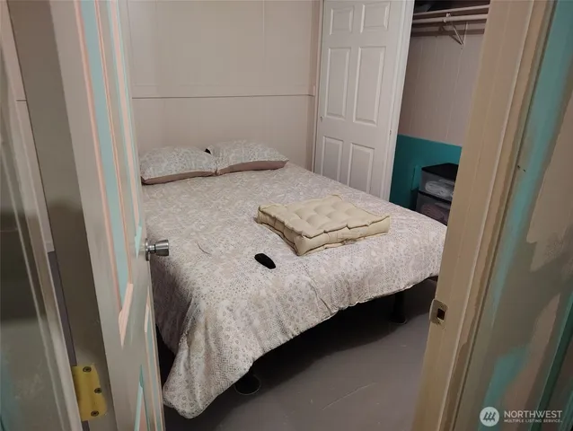 a bedroom with a bed and a window