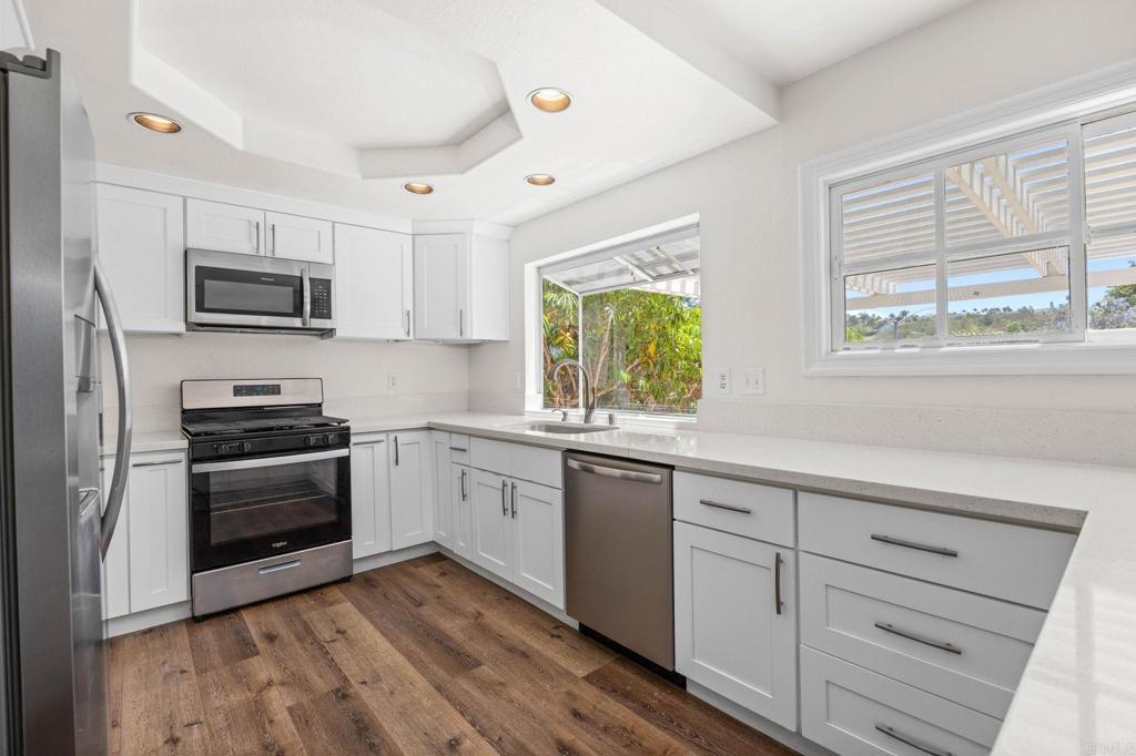 4595 Blackwell Road Oceanside, CA 92056 - Photo 14 of 47 a kitchen with granite countertop cabinets stainless steel appliances and a window