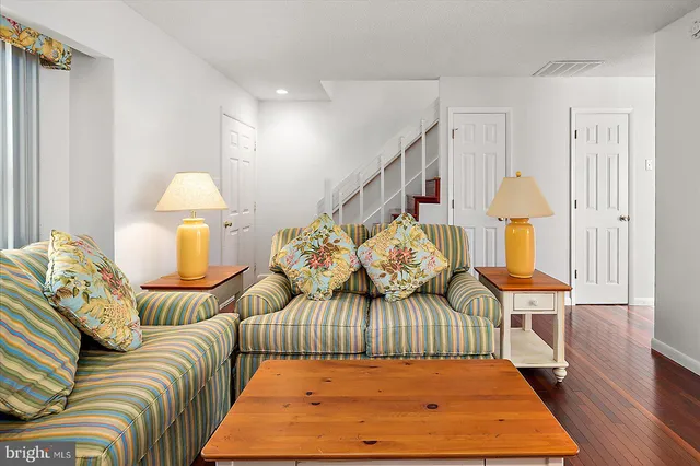 a bedroom with a bed and a wooden floor