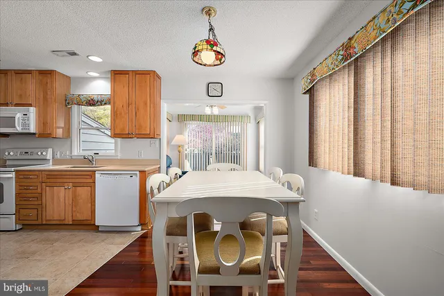a kitchen with stainless steel appliances granite countertop wooden cabinets a sink and a stove