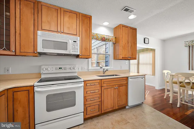 a dining room with a wooden table and chairs