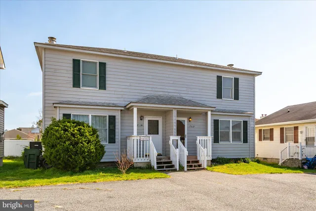 a view of a house with a swimming pool and a yard