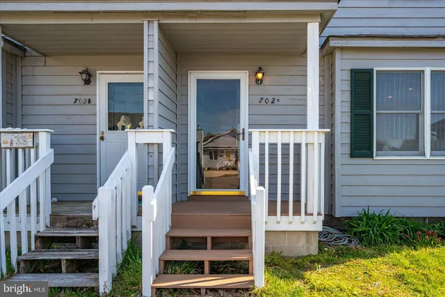 a view of front door of house with stairs