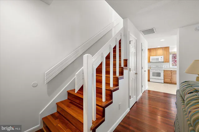 a view of entryway and hall with wooden floor