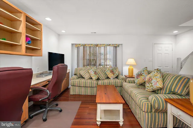a living room with furniture a rug and a piano