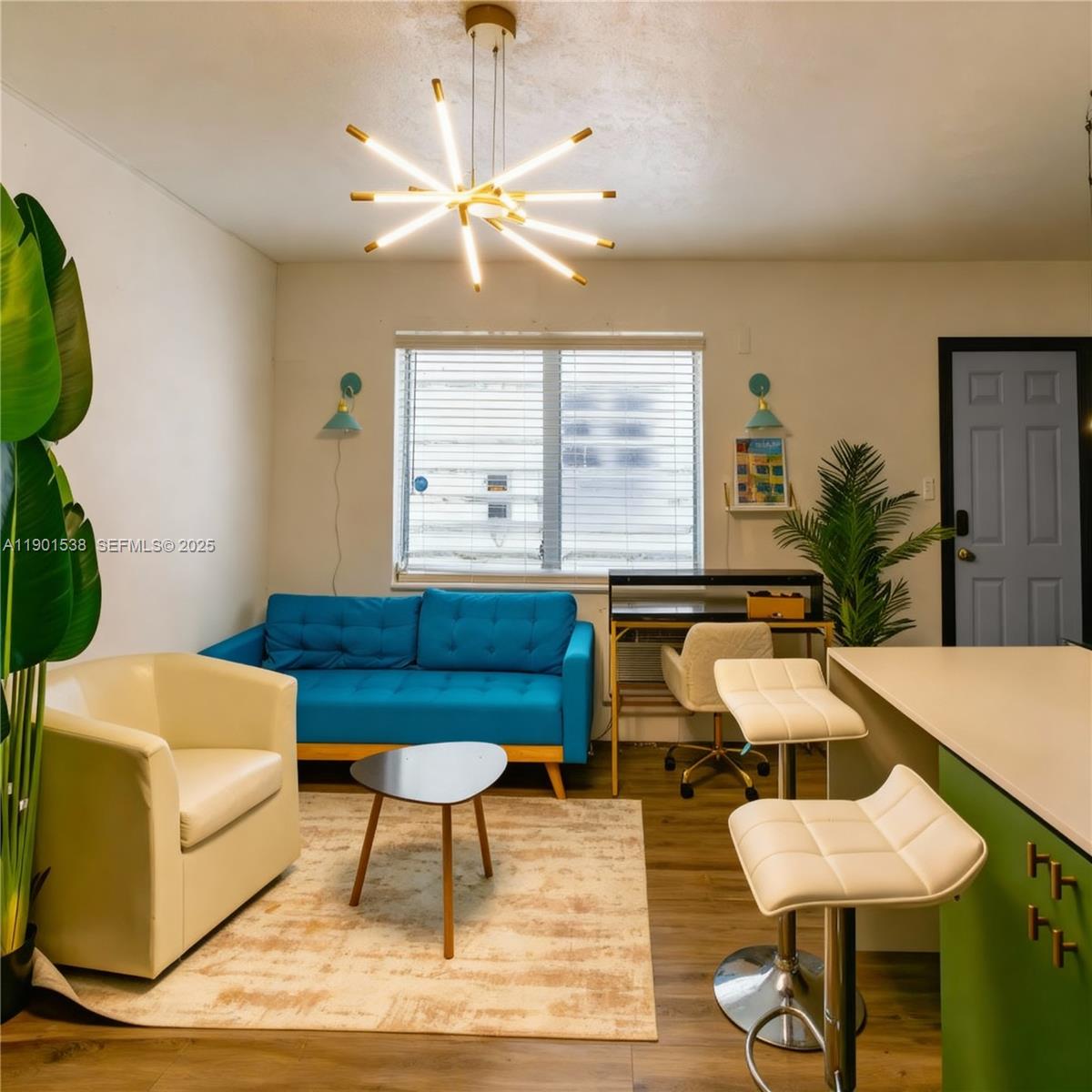 a living room with furniture and a chandelier