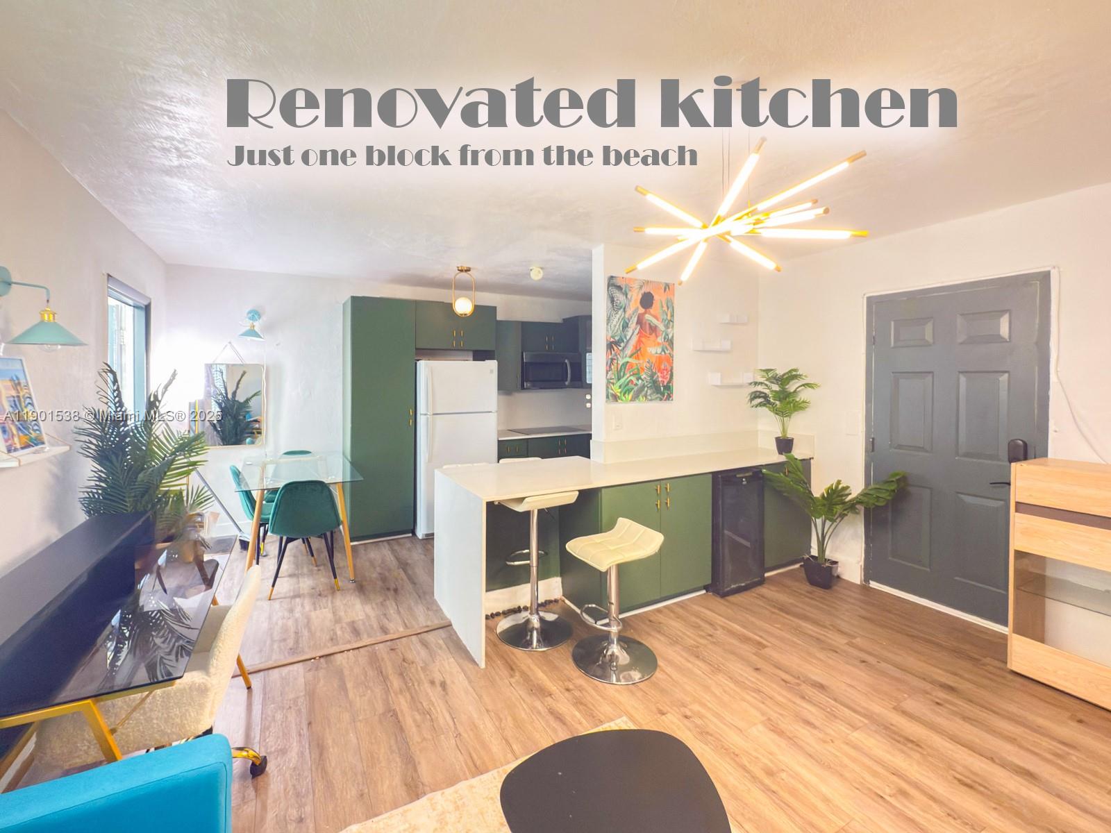 7928 Harding Avenue, Unit 2 Miami Beach, FL 33141 - Photo 11 of 19 a living room with furniture a dining table and chairs with wooden floor