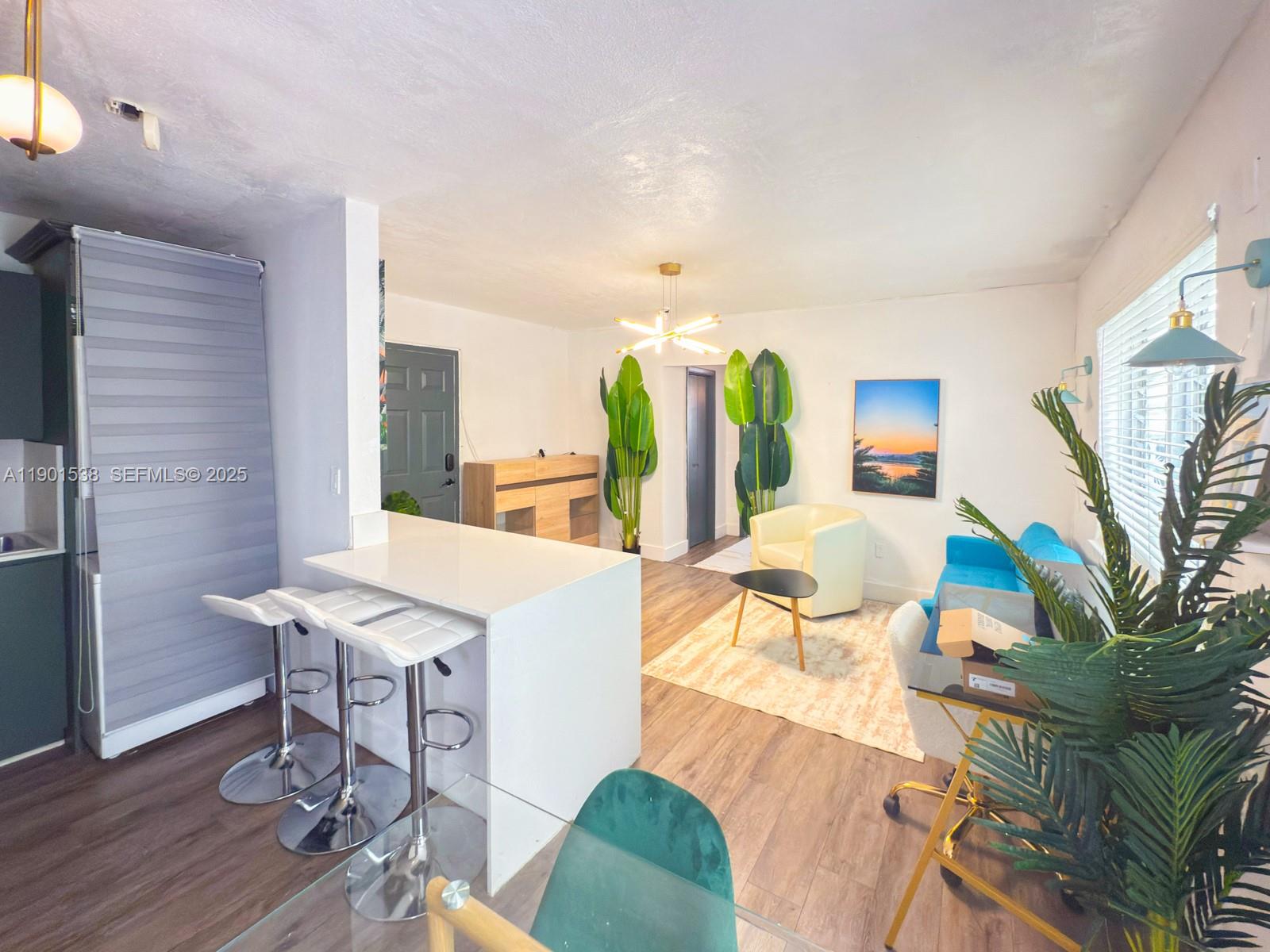 7928 Harding Avenue, Unit 2 Miami Beach, FL 33141 - Photo 2 of 19 a view of a dining room with furniture window and wooden floor
