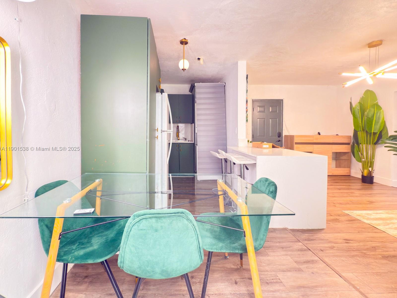 7928 Harding Avenue, Unit 2 Miami Beach, FL 33141 - Photo 3 of 19 a view of a dining room with furniture and wooden floor