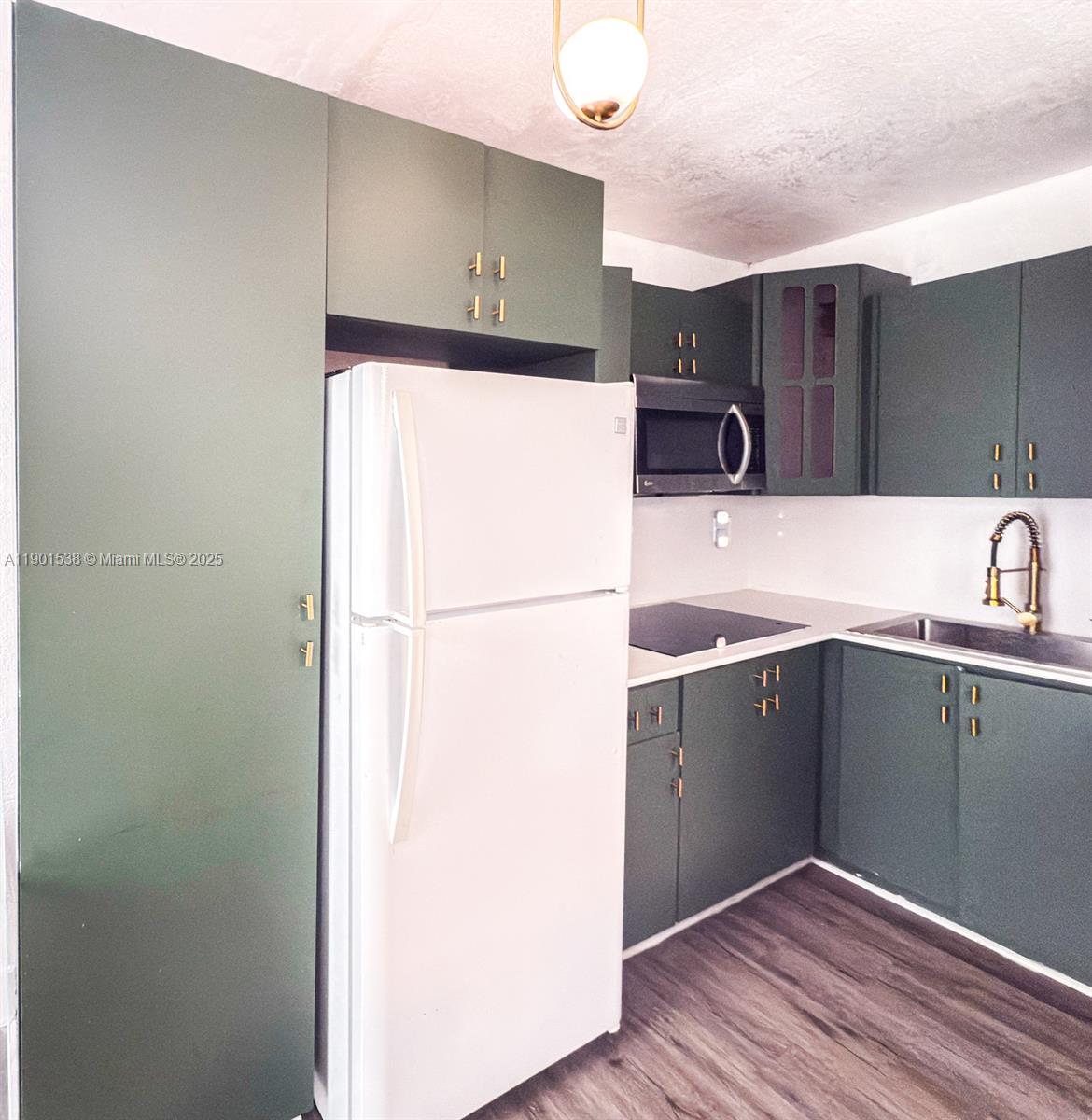 7928 Harding Avenue, Unit 2 Miami Beach, FL 33141 - Photo 5 of 19 a kitchen with cabinets and stainless steel appliances
