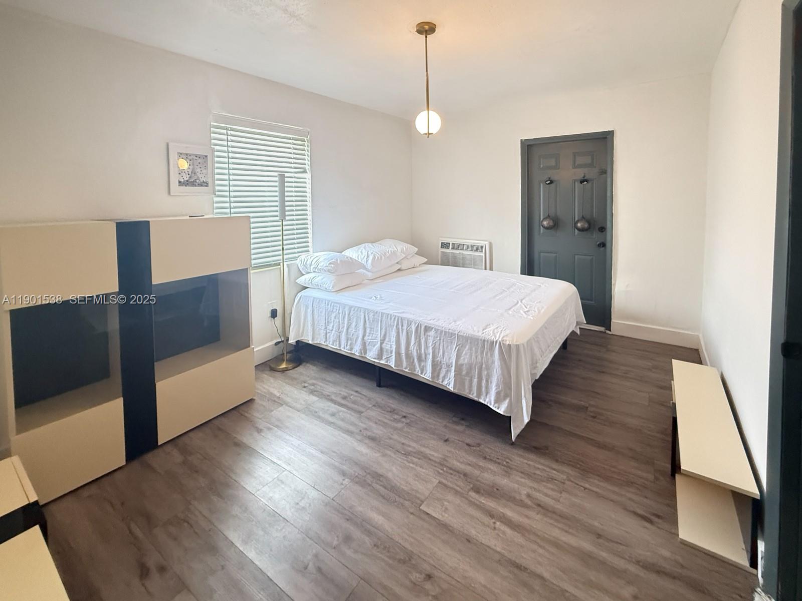 7928 Harding Avenue, Unit 2 Miami Beach, FL 33141 - Photo 9 of 19 a bed room with a bed and a night stand