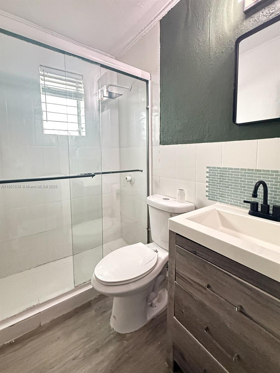 7928 Harding Avenue, Unit 2 Miami Beach, FL 33141 - Photo 10 of 19 a bathroom with a toilet a sink and shower